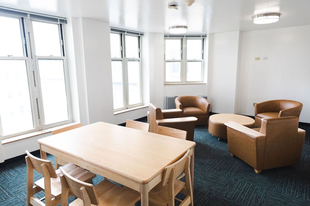 New table and lounge chairs in student lounge