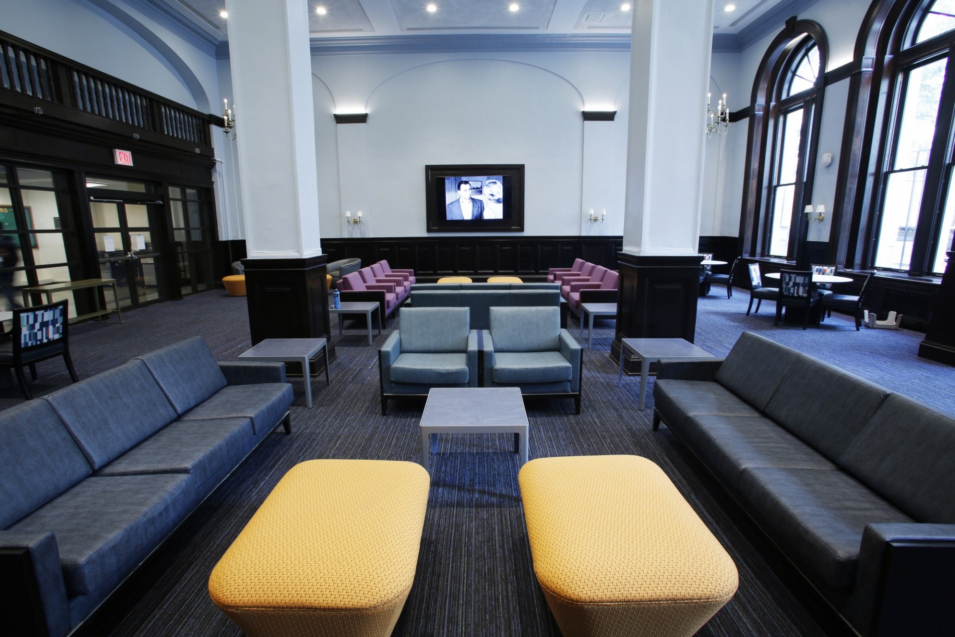 A view of seating and large screen television in John Jay Lounge.