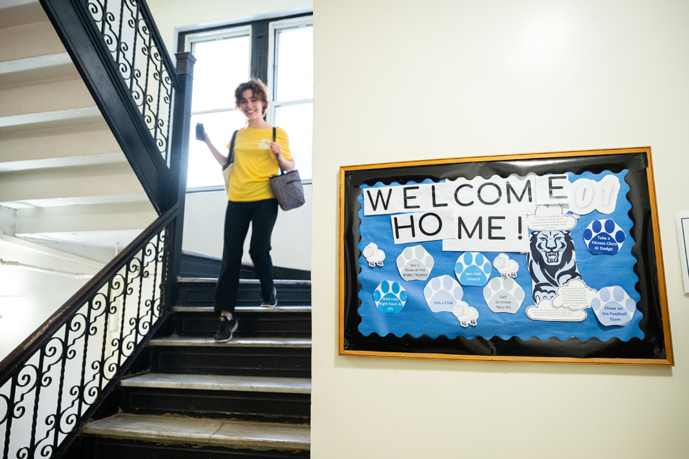 A student heads down the stairwell in a Columbia residence hall.
