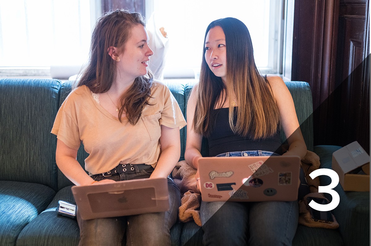 #3: Two students sit on a couch with their laptops