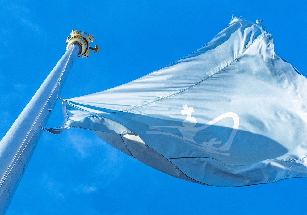 The Columbia flag waving in the wind against a bright blue sky