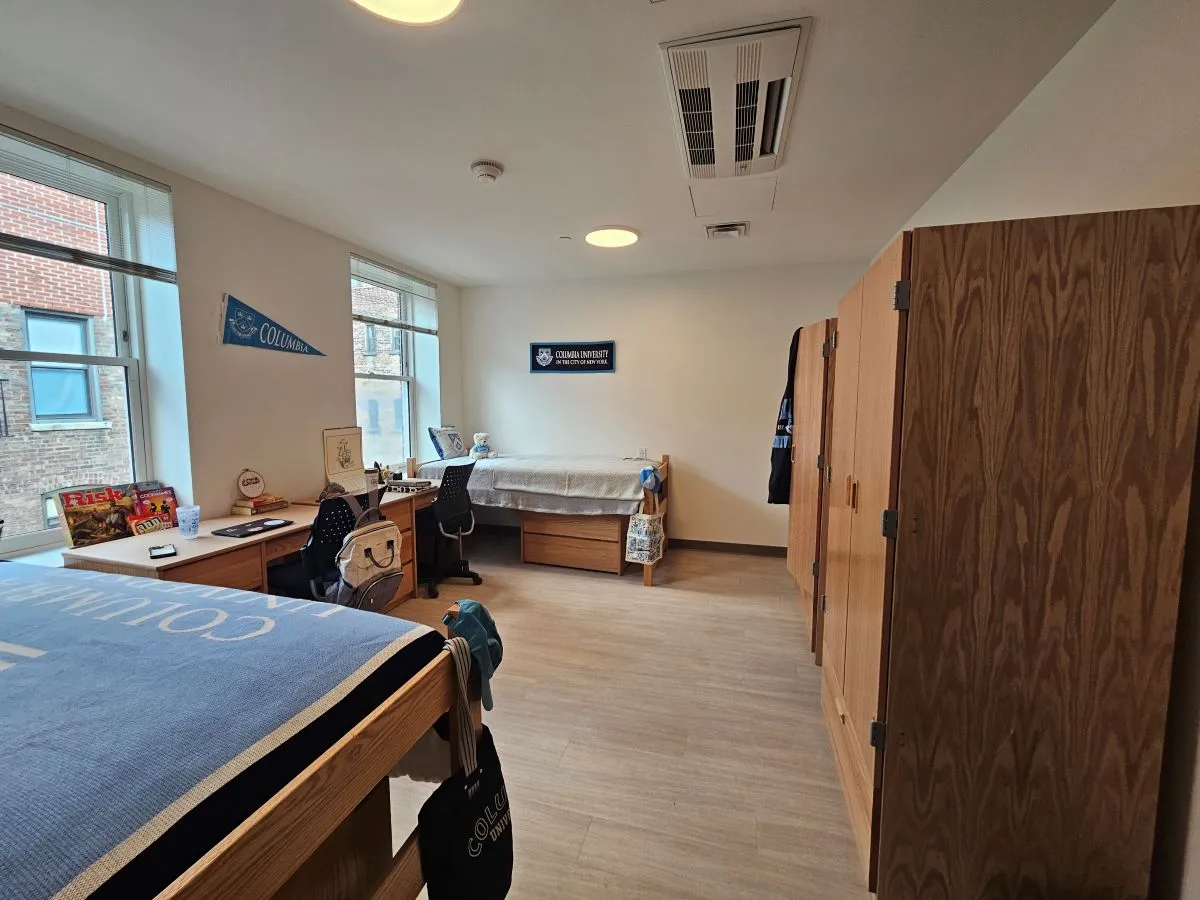 double room showing two beds, two desks, and two dressers