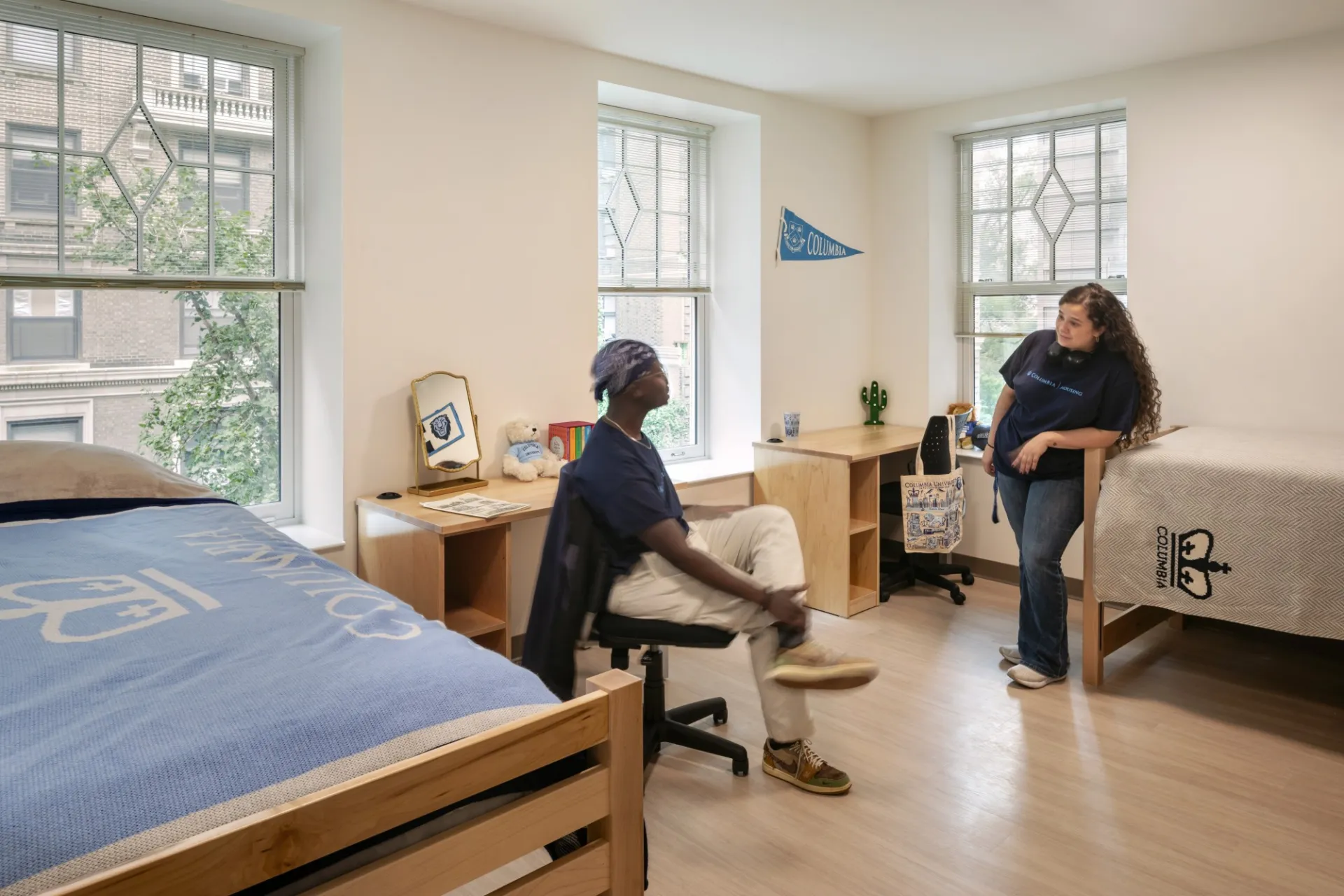 Two students in a double room, featuring two beds and two desks