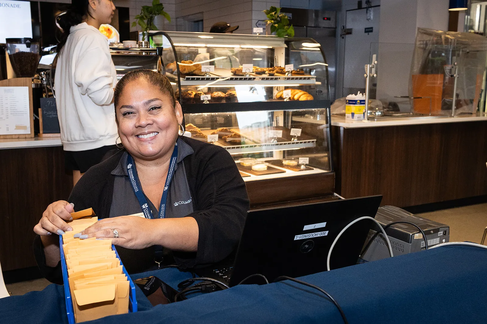 A housing staff member at a Check-In table