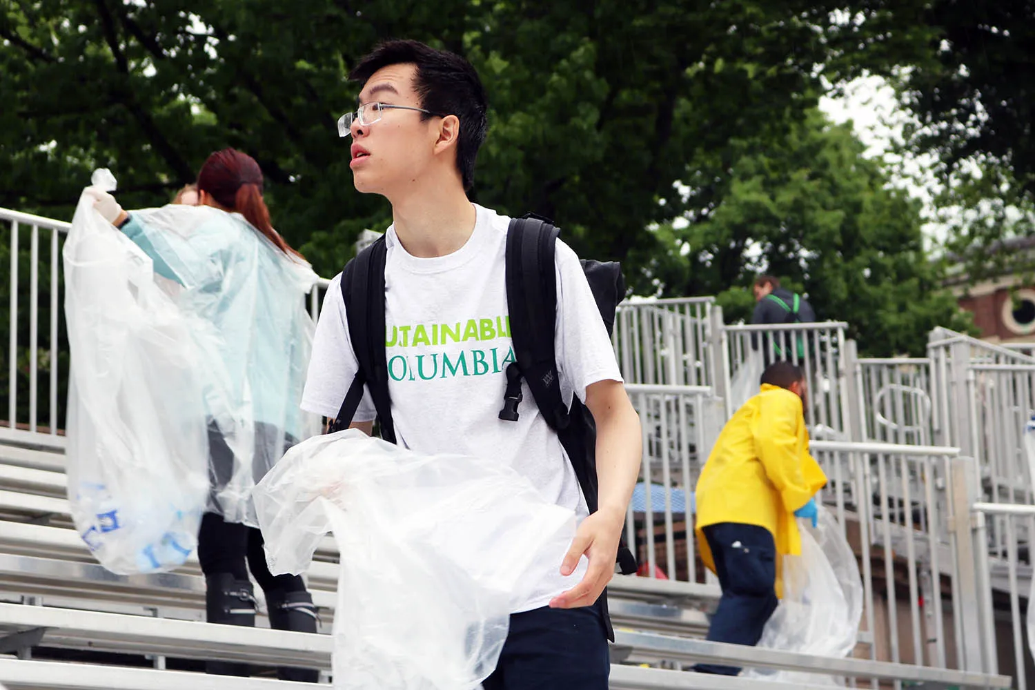EcoReps collecting water bottles in the bleachers after Commencement