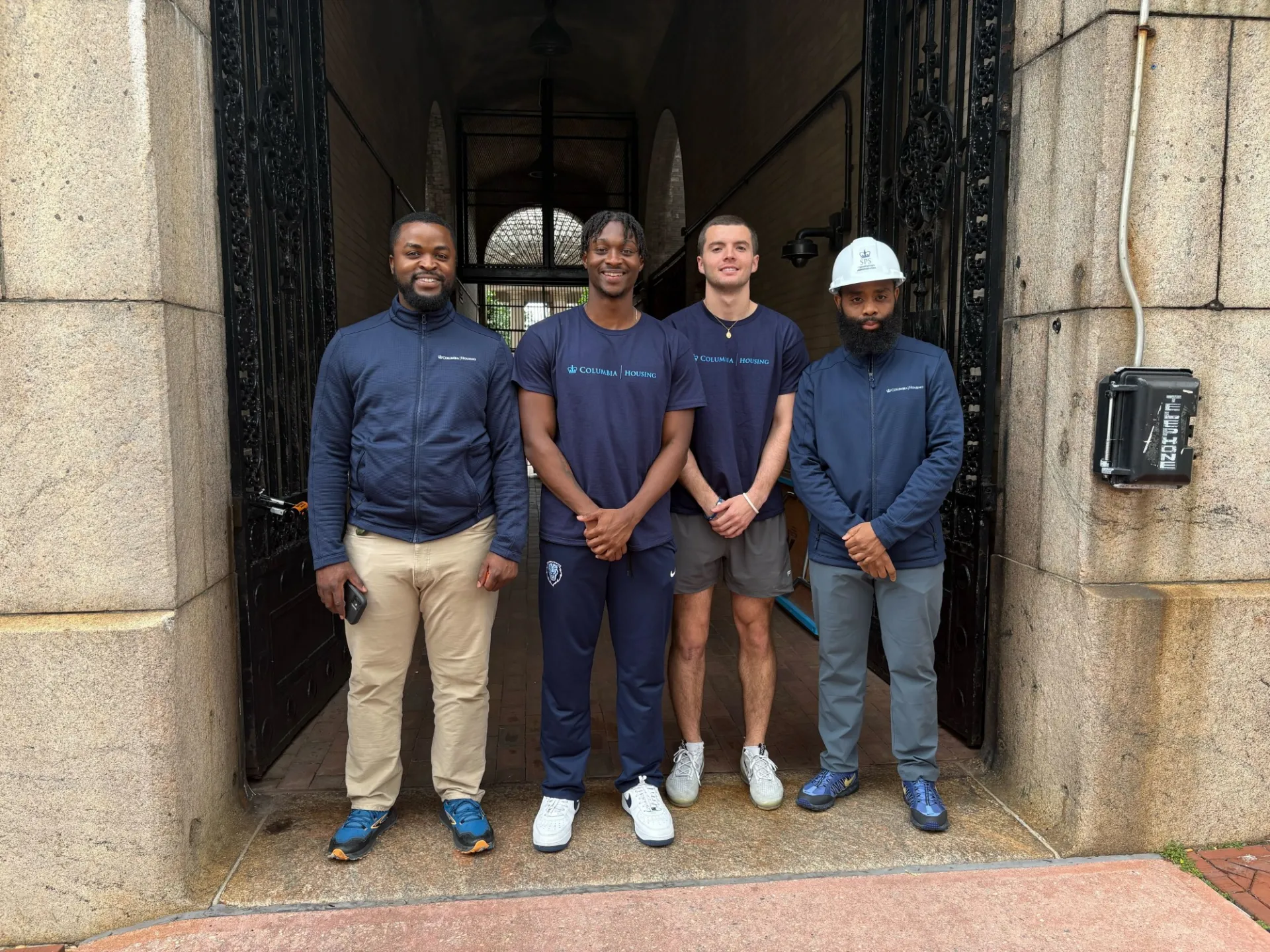 Housing employees and interns pose outside of Hartley